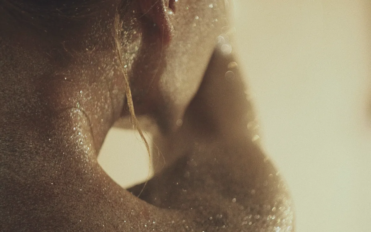 Light catching across a shoulder, held close.